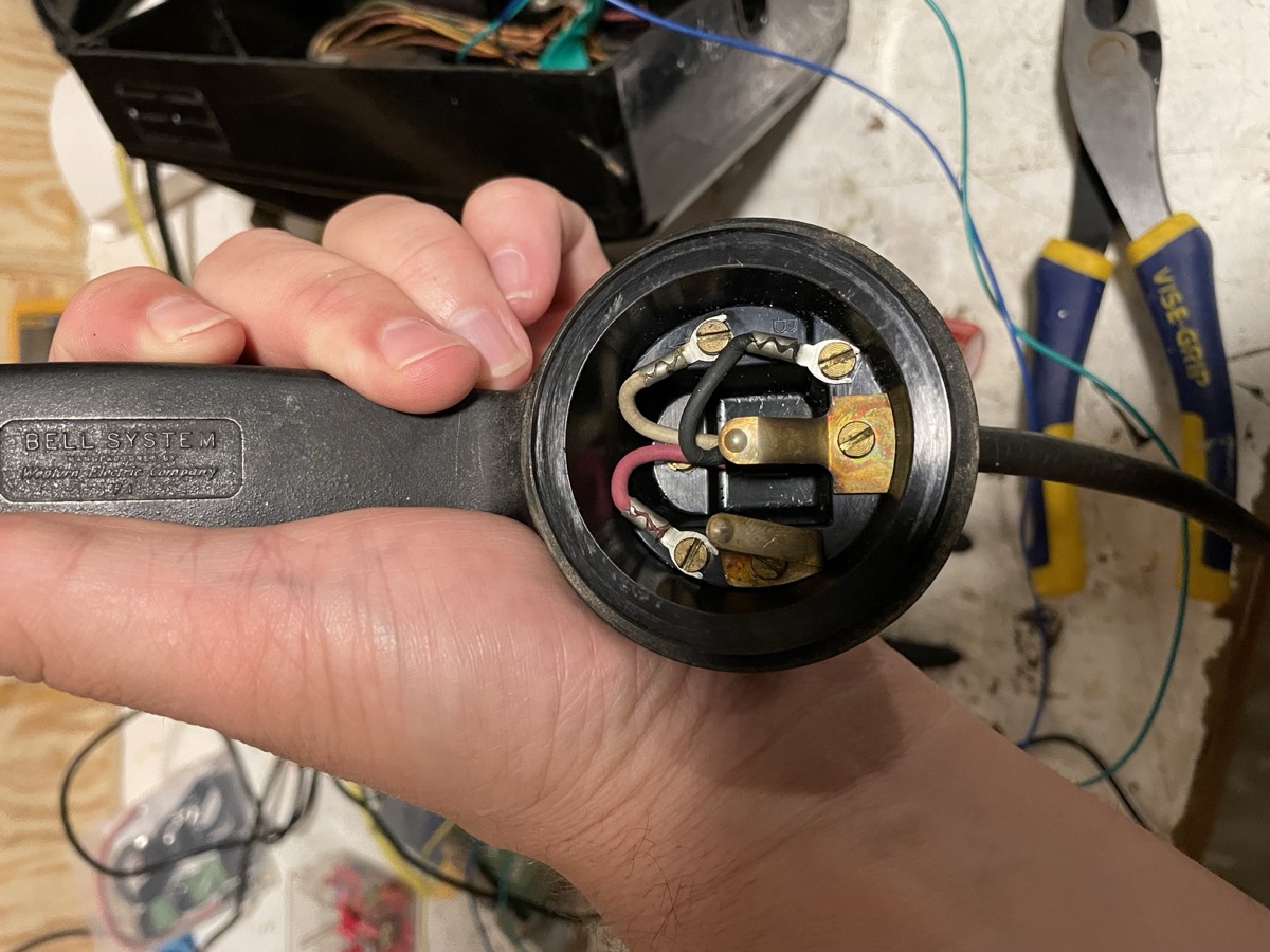 Close-up of the Bell System handset opened up to show the receiver terminals and wiring